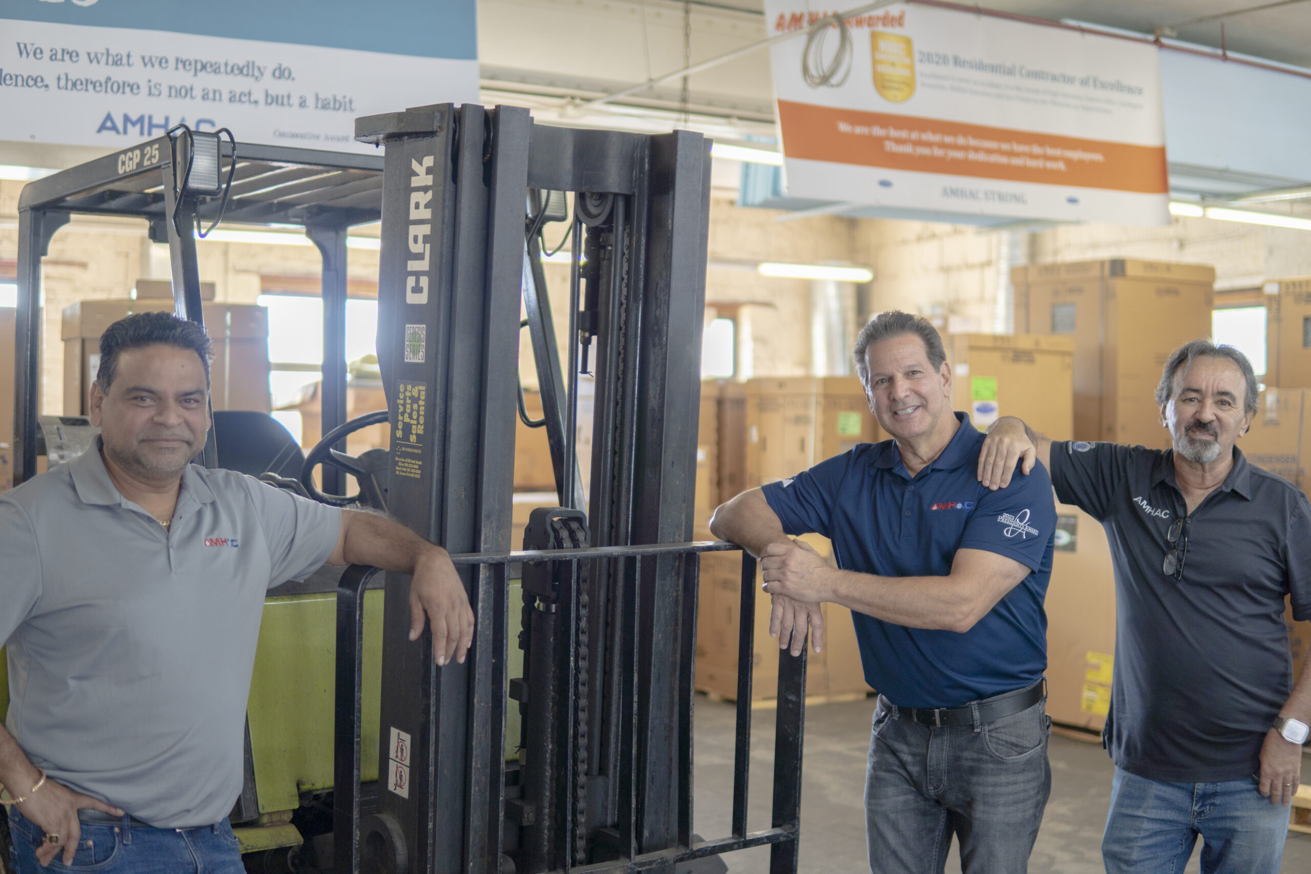 Three AMHAC team members posing at their warehouse - OnCall Air Customer First Award