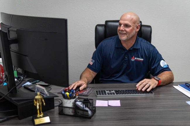 Roy Shell looking at his computer