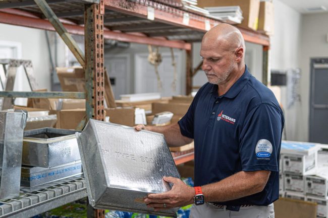 Roy Shell holding an AC part