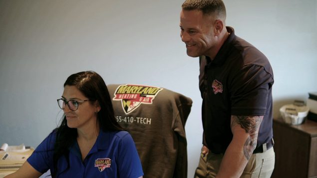 Chris Langston, owner of Maryland Heating & Air, engages in discussion with an employee at their Baltimore HQ.