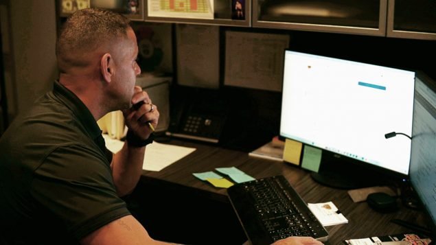 Chris Langston, owner of Maryland Heating & Air, focused at his desk while using the OnCall Air platform to craft a detailed HVAC proposal.