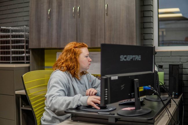 Stoudenmire employee 1 in front of computer
